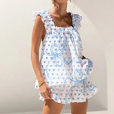 Woman wearing a white dress with blue patterns